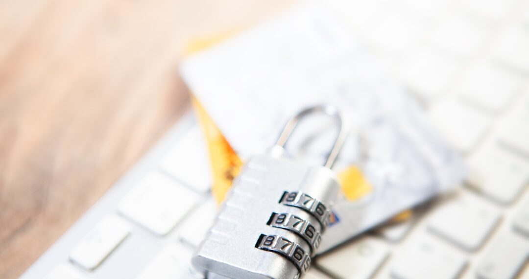 Closeup of a padlock on a computer keyboard and credit card