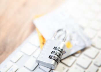 Closeup of a padlock on a computer keyboard and credit card