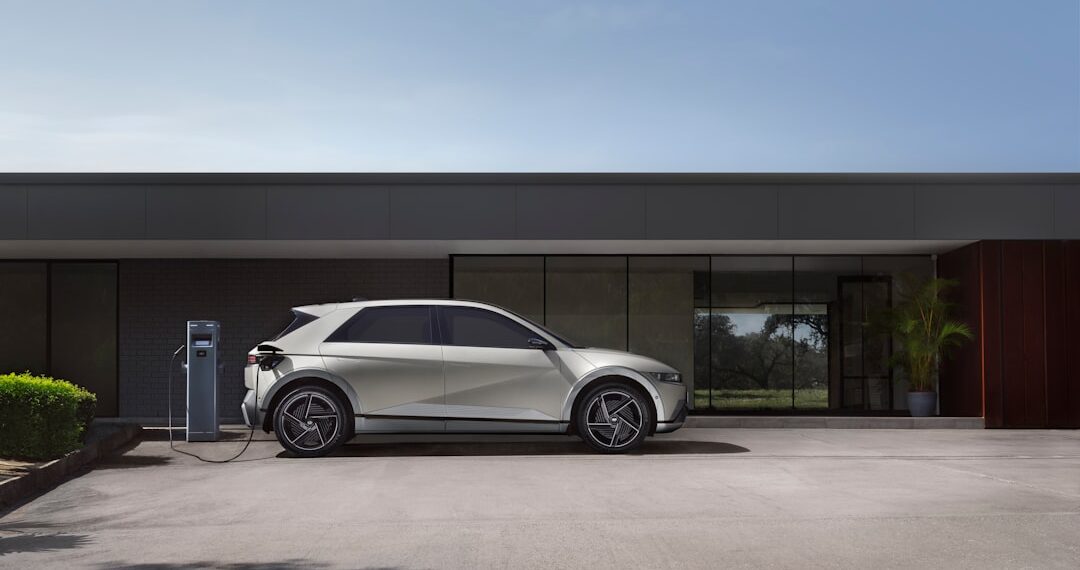 The right side view of the Hyundai IONIQ 5 charging in front of a building.