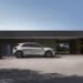 The right side view of the Hyundai IONIQ 5 charging in front of a building.