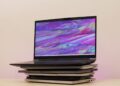 Gaming laptop on top of stacked laptops