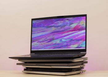 Gaming laptop on top of stacked laptops